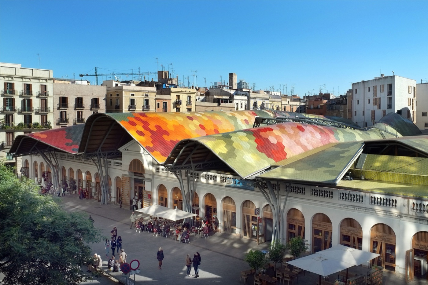 The multicoloured tiled roof and arched facade of Mercat de Santa Caterina